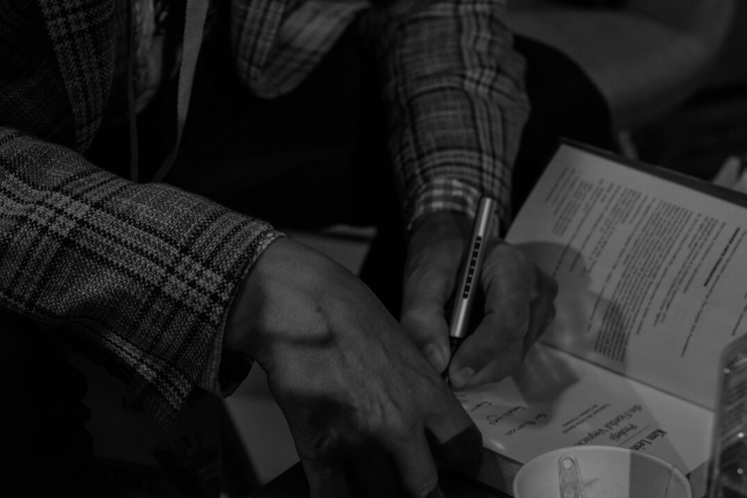 businessman signing donation papers